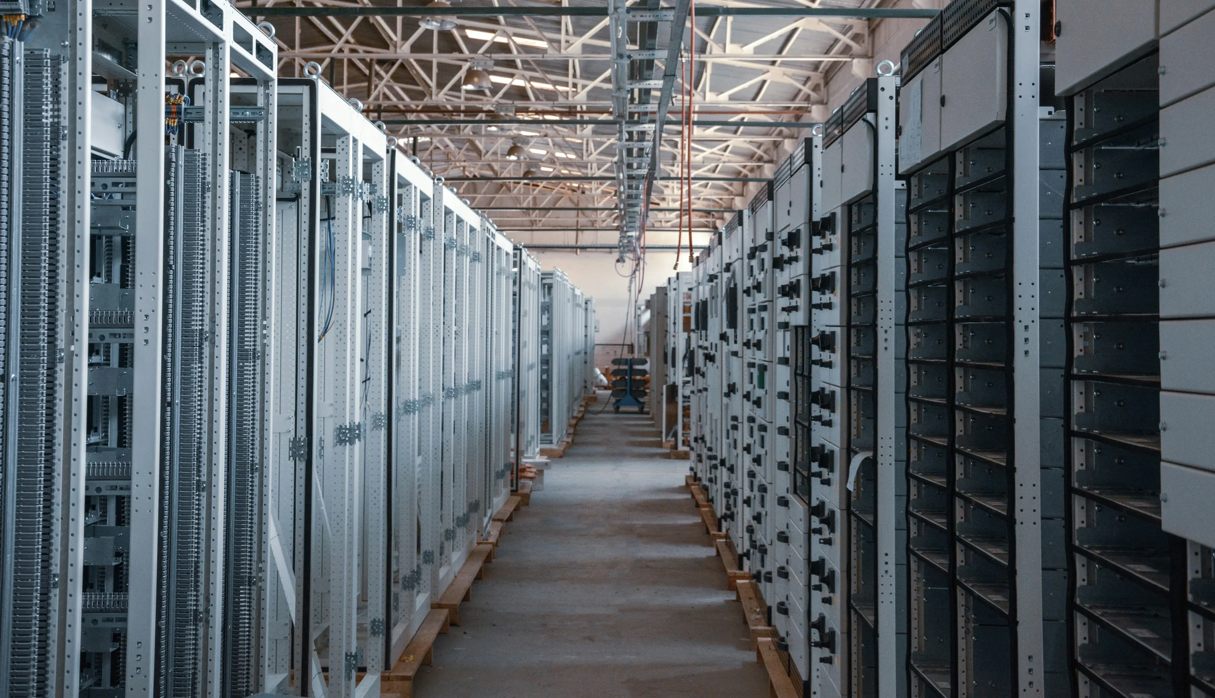 A corridor of server racks inside an operating data center